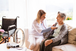 nursing helping older woman